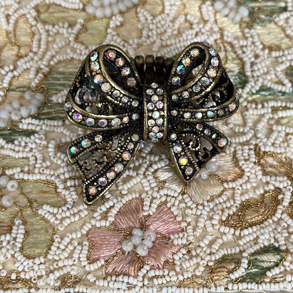 Aurora borealis crystal bow adjustable ladies ring antique brass finish